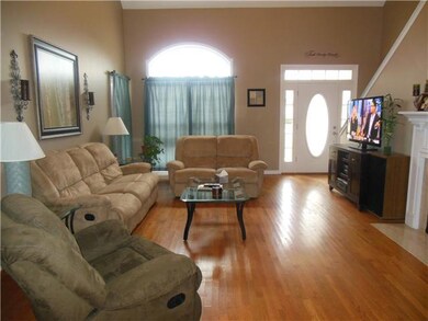 Very spacious living room with fireplace looking from the kitchen