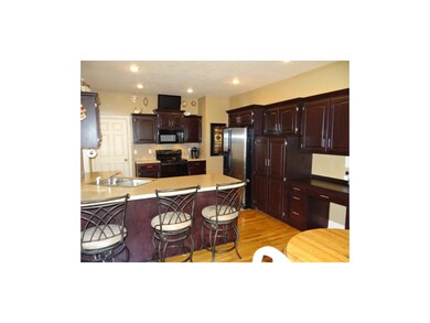 Open Kitchen With Dark Cherry Wood Cabinetry, Buil