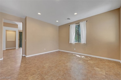 Empty room with baseboards and recessed lighting