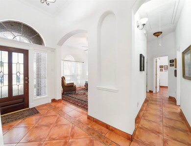 Beautiful leaded glass and wood front door, opens up to the study or formal living room.