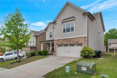 Craftsman-style house with a garage, stone siding,