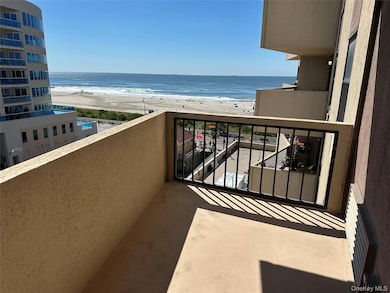 Balcony with view of water and beach