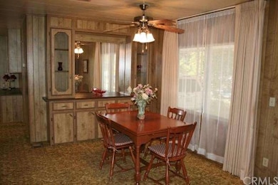 Dining room with ceiling fan and built-in hutch.