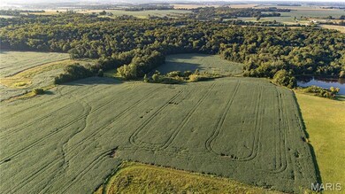 Aerial view of property's location with rural landscape and a nearby body of water