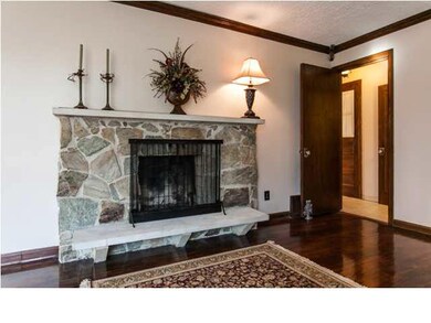 Stone fireplace in living room has beautiful shade