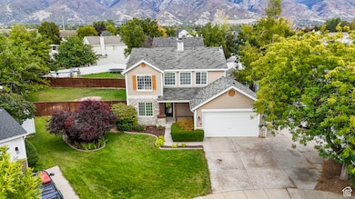 Traditional home featuring stone siding, a mountain view, and a garage