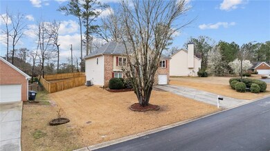 View of front of home with driveway, a garage, fen