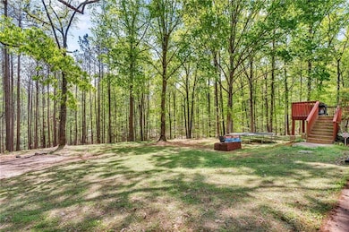 View of yard featuring stairway, a view of trees, 
