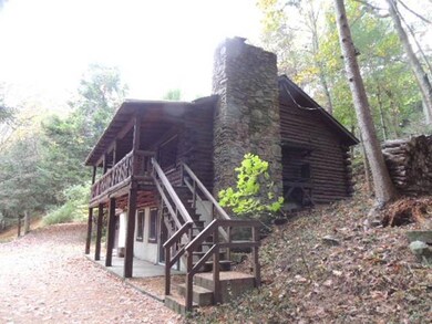 Side view of stone chimney and steps leading to co