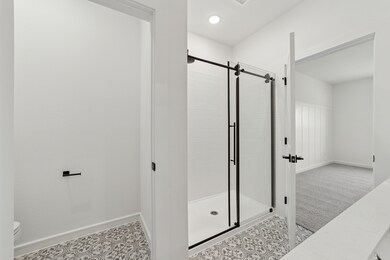 Primary bath with glass shower enclosure