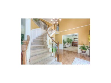 Impressive Two Story Entry Sweeping Staircase with