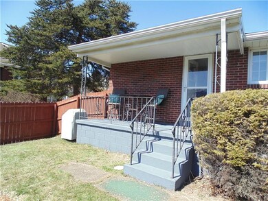 Covered back porch with new roof overlooking fence