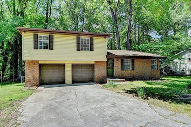 Tri-level home featuring asphalt driveway, a garag
