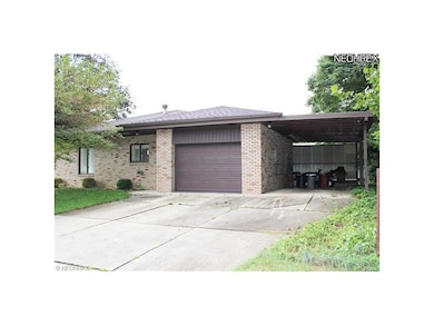 16th St. view of attached garage and carport