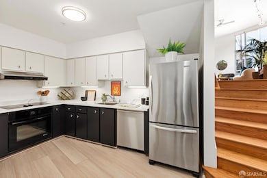 Tucked away down a short flight of stairs from the great room is the modern kitchen.