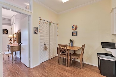 Dining area with crown molding and wood finished 