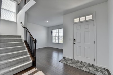 Entryway featuring wood-type flooring, baseboards,