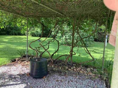 covered patio with adjoining arbor