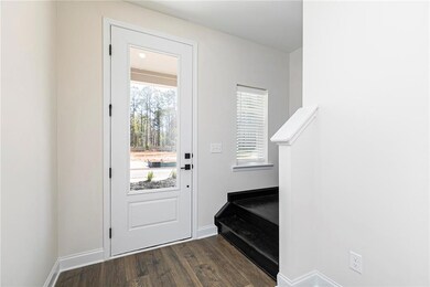 Doorway with stairway and wood finished floors