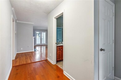 Corridor featuring light wood finished floors, bas