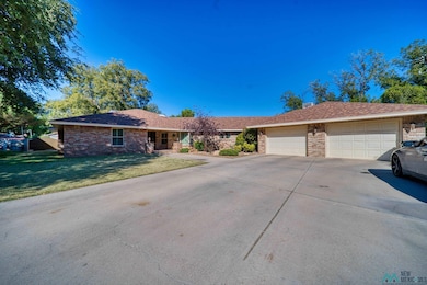 Ranch-style home with a front lawn, concrete driveway, an attached garage, covered porch, and roof with shingles