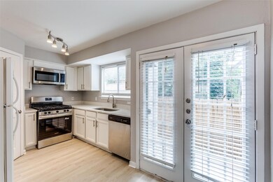 Kitchen featuring stainless steel appliances, lig