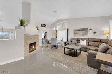 Living room featuring a notable chandelier, basebo