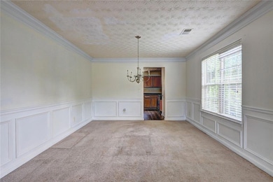 Unfurnished dining area featuring a chandelier, ca