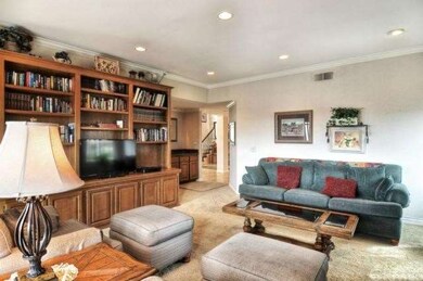 The family room has tasteful built in cabinetry, d