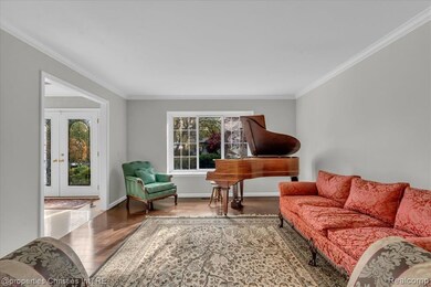 Living area featuring crown molding, french doors, and wood finished floors