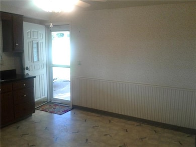 Entry off Kitchen and eating area with chair rail 