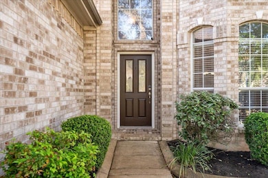 Doorway to property with brick siding