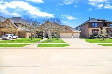 Wide Driveway to a 3 car garage with automatic remote door opener. Pleasant walkway to the arch entry way covered porch.