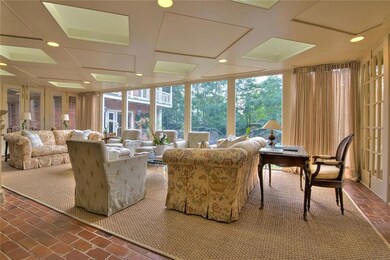 Bright and comfortable sunroom overlooks pool and