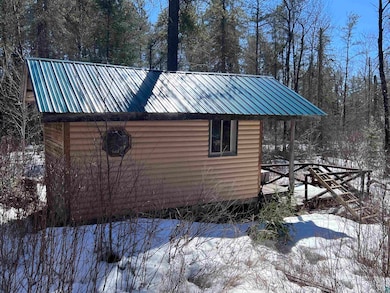 Exterior space with metal roof and an outbuilding