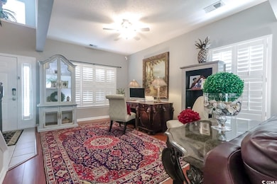 Home office featuring a ceiling fan and wood finished floors