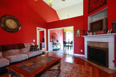 Vaulted Family Room With Gas Fireplace, New Hardwoods and TV Mount above FP.