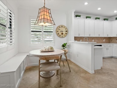 Dining space with ornamental molding and light tile patterned flooring