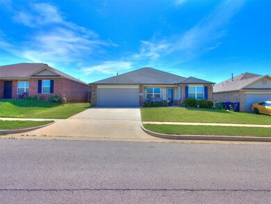 Ranch-style home with a garage and a front lawn