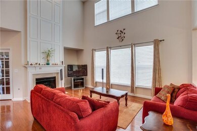 Spacious two story great room offering hardwood floors, gas fireplace, and full wall of windows.