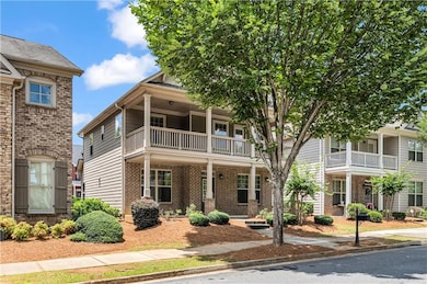 View of front of home featuring a balcony and brick siding