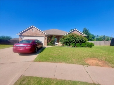 View of front facade with driveway, an attached garage, and brick siding