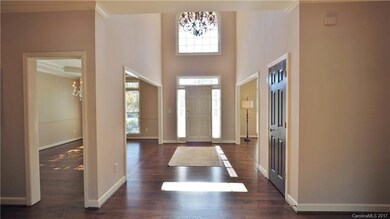 The 2 Story Foyer with Hardwood Floors greets gues