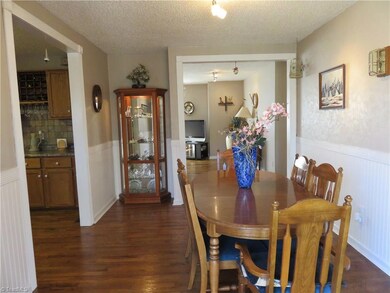 Refinished oak flooring in kitchen, dining, living, and hallway