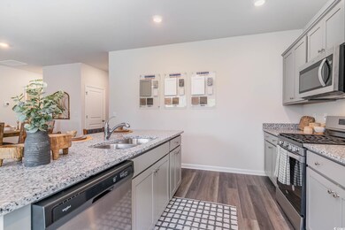Kitchen with stainless steel appliances, a sink, d