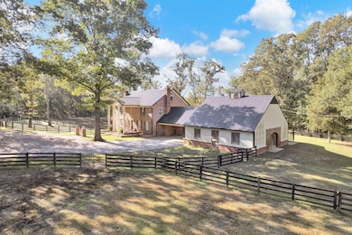 View of horse barn with a rural view