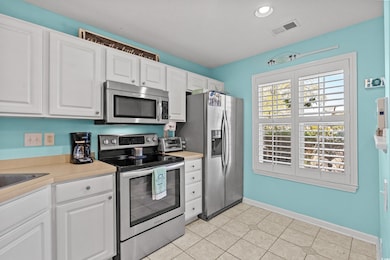 Kitchen featuring stainless steel appliances, ligh