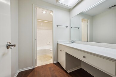 Full bathroom featuring vanity, wood finished flo