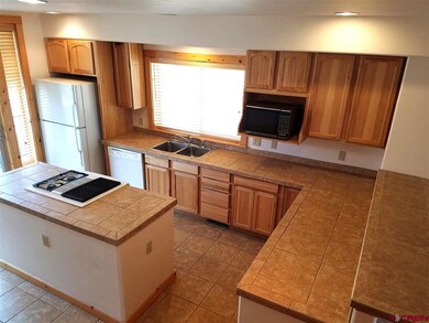 Wood cabinets, Tile counter top, bar and island