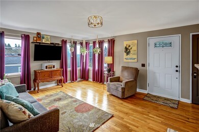 Enter the living room with loads of windows and original hardwoods